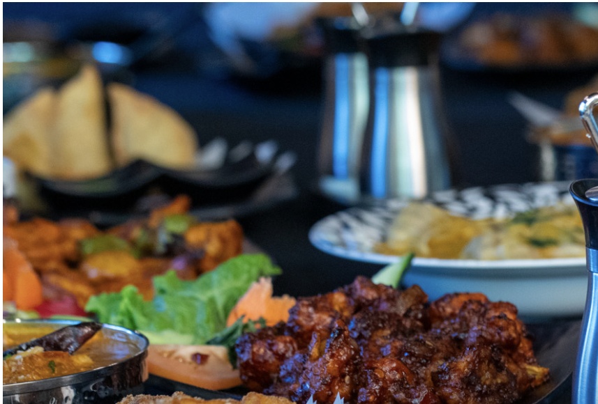A table of curries and appetizers at Zen Curry and Grill