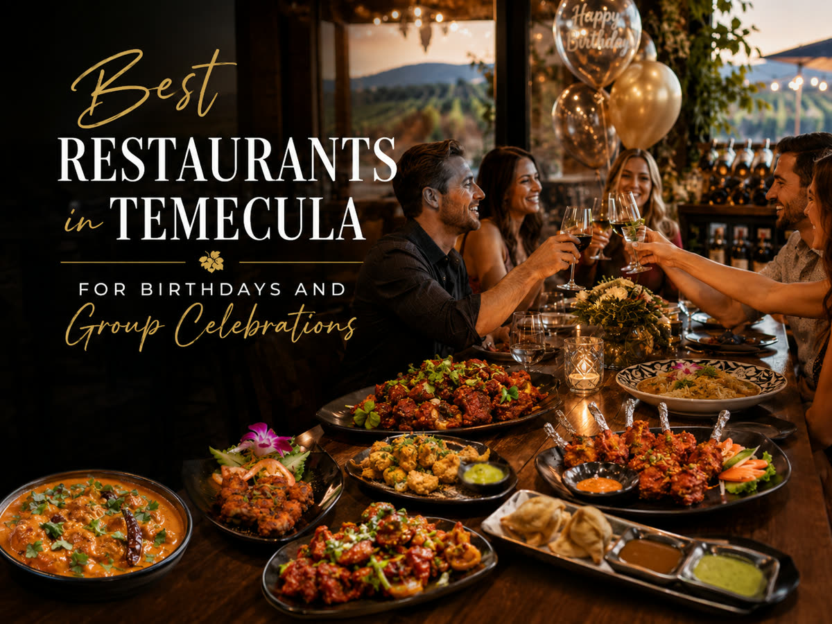 Friends raising a toast over a spread of Indian food at a birthday dinner at Zen Curry and Grill in Temecula